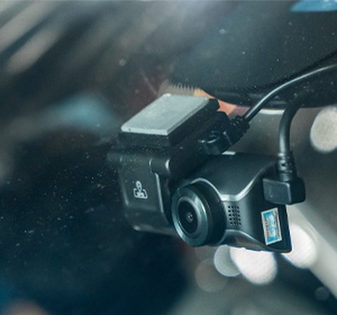 Car interior at night showing a windshield mounted recording camera in use Car interior at night showing a windshield mounted recording camera in use