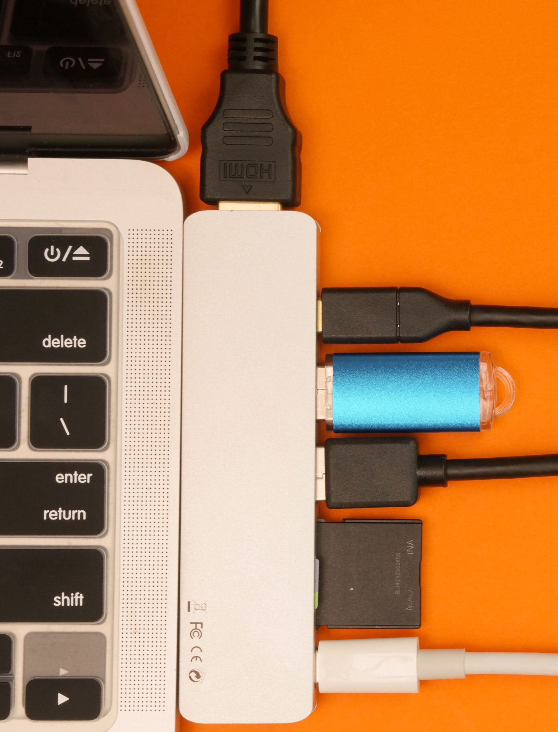 USB hub adapter attached to laptop on desk USB hub adapter attached to laptop on desk