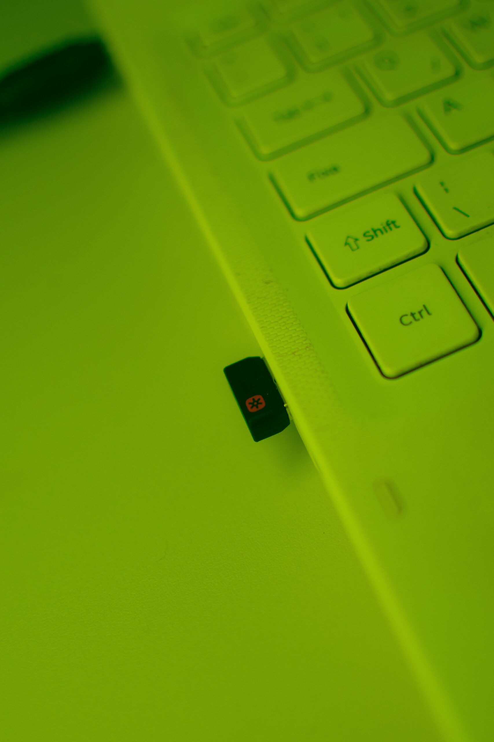 Small USB adapter dongle connected to a laptop Small USB adapter dongle connected to a laptop
