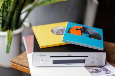 Cayin Mini-CD MK2 CD player with compact discs on a shelf Cayin Mini-CD MK2 CD player with compact discs on a shelf