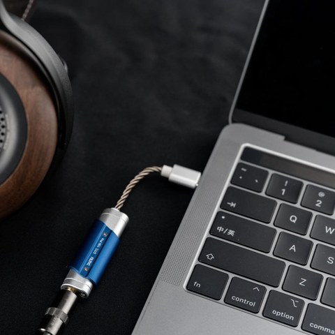 DUNU DTC100 Pro dongle DAC connected to laptop next to headphones