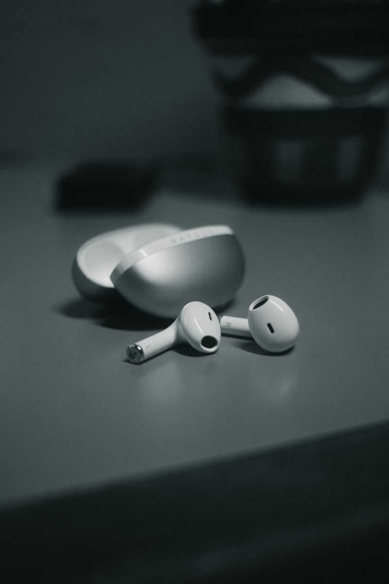 Earbuds and charging case on a table Earbuds and charging case on a table