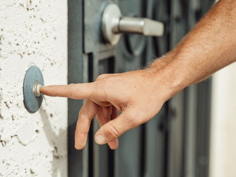 Close-up finger press on a doorbell button similar to HP7 outdoor unit