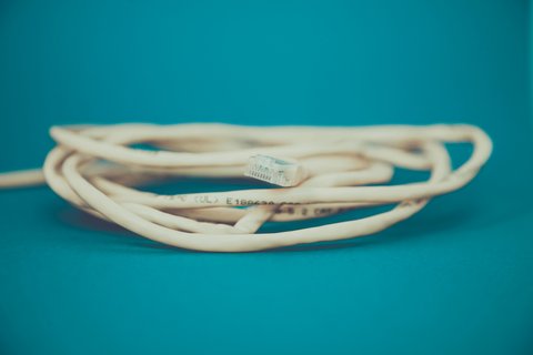 Coiled network cable representing PoE camera cable run planning Coiled network cable representing PoE camera cable run planning