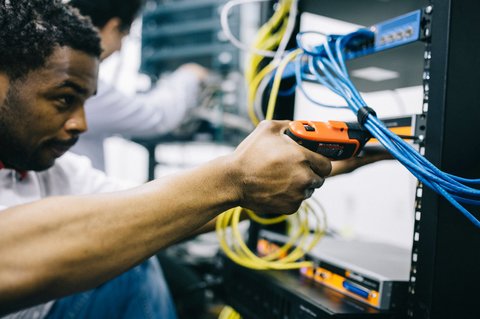 Technician installing network cables similar to an X5C NVR setup Technician installing network cables similar to an X5C NVR setup