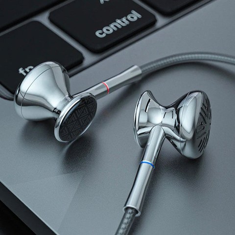 FiiO FF3 earbuds with swappable plug cable on laptop keyboard