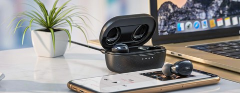 FiiO FW1 earbuds and case on desk with laptop FiiO FW1 earbuds and case on desk with laptop