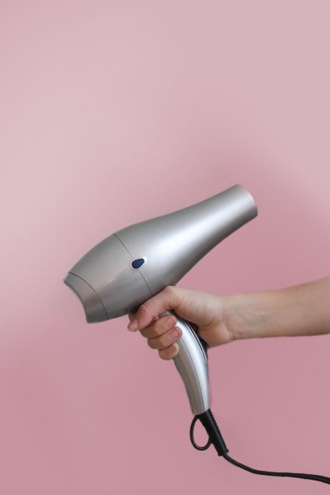 Hand holding a hair dryer similar to a SOOCAS model Hand holding a hair dryer similar to a SOOCAS model