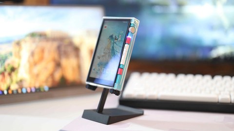 HiBy M500 angled view on a desk stand showing the touchscreen display HiBy M500 angled view on a desk stand showing the touchscreen display