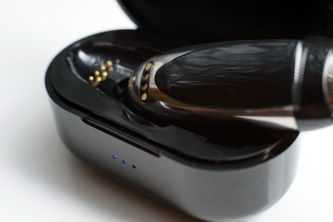 HiBy W5 seated in its charging cradle case with pogo-pin contacts visible HiBy W5 seated in its charging cradle case with pogo-pin contacts visible