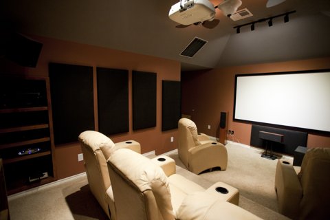 Home theater room with projector screen and seating Home theater room with projector screen and seating