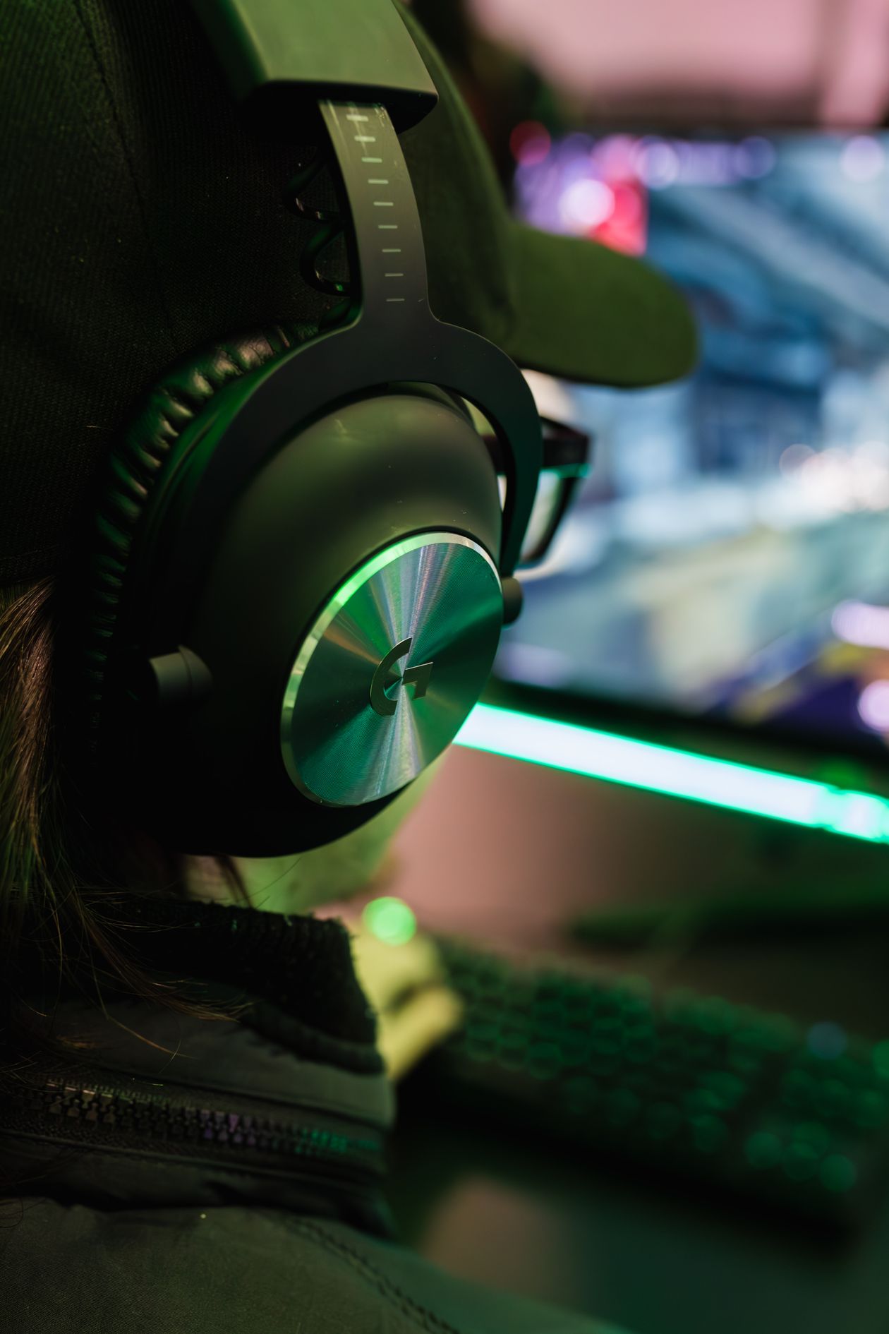 Gamer wearing an over-ear headset in a gaming lounge Gamer wearing an over-ear headset in a gaming lounge