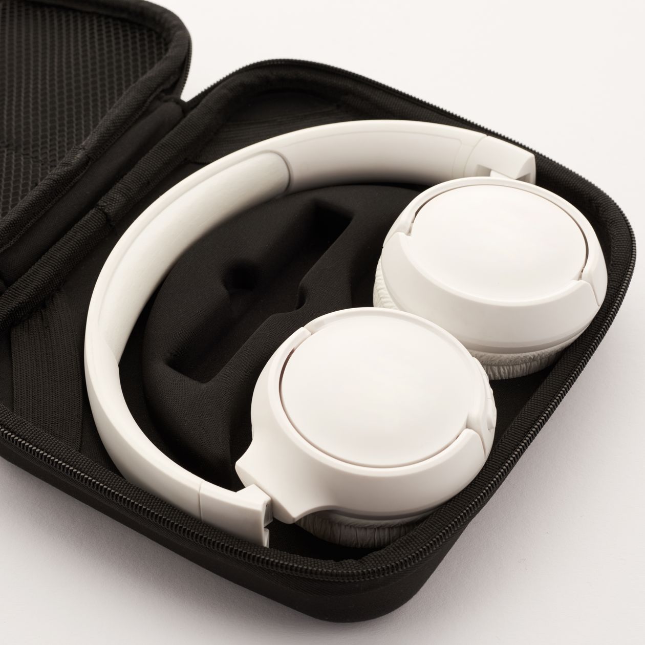 Wireless headphones stored in a protective carrying case Wireless headphones stored in a protective carrying case