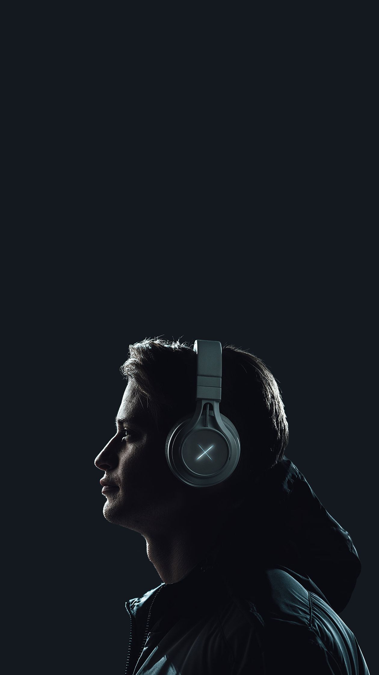 Side profile of a person wearing over-ear wireless headphones Side profile of a person wearing over-ear wireless headphones