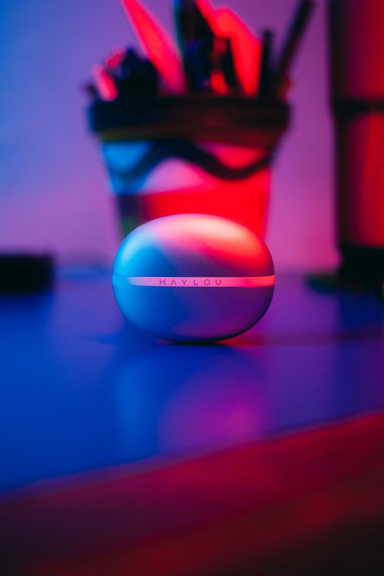 Wireless earbuds resting in an open charging case Wireless earbuds resting in an open charging case