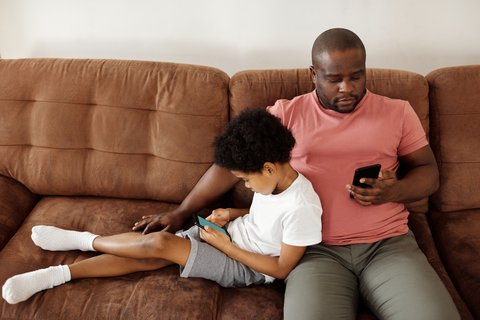 Two people using smartphones at home, similar to checking the free Reolink app Two people using smartphones at home, similar to checking the free Reolink app