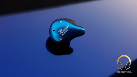 TFZ X1 single earbud close-up showing branding and button TFZ X1 single earbud close-up showing branding and button