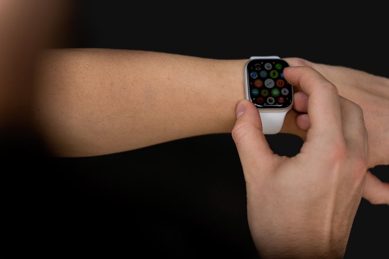 Hand holding a smartwatch Hand holding a smartwatch