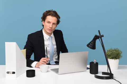 Laptop on a desk used for syncing a portable media player Laptop on a desk used for syncing a portable media player