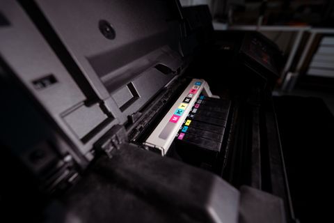 Open printer showing ink cartridges inside the housing Open printer showing ink cartridges inside the housing