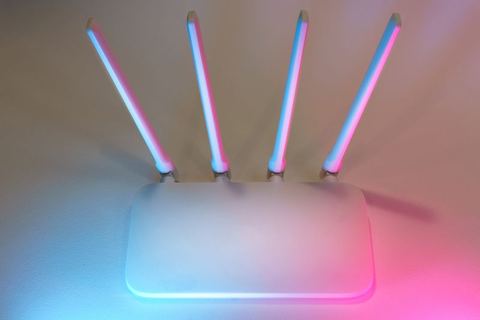 Wireless network router with glowing antenna signal Wireless network router with glowing antenna signal