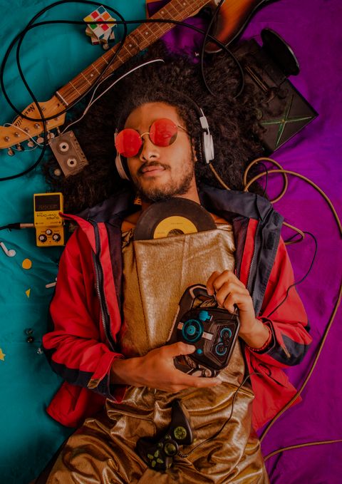 Man listening to music through headphones with a portable player