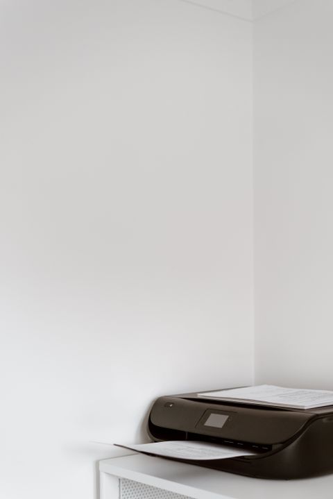 Modern inkjet printer with paper loaded in a home office Modern inkjet printer with paper loaded in a home office