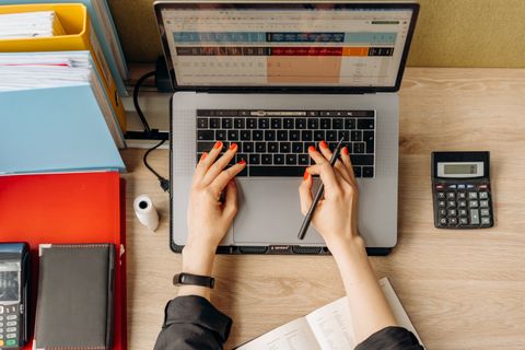 Person using a laptop at a work desk setting up software Person using a laptop at a work desk setting up software