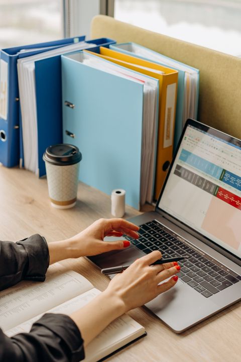 Person typing on a laptop keyboard at a desk