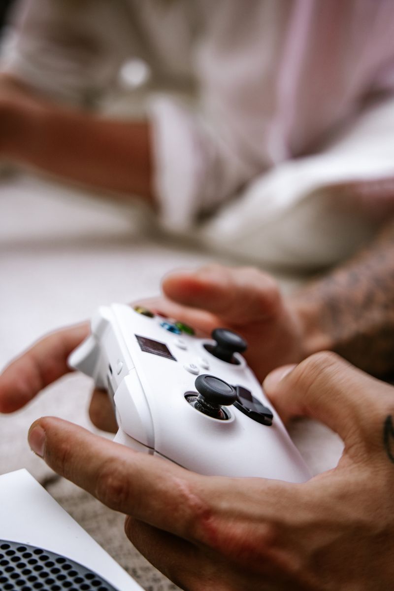 Wireless game controller held in hand while gaming Wireless game controller held in hand while gaming