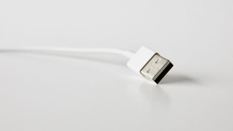 White USB cable used to connect a portable music player White USB cable used to connect a portable music player