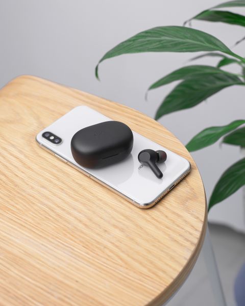 Wireless earbuds and smartphone placed together for a firmware update session Wireless earbuds and smartphone placed together for a firmware update session