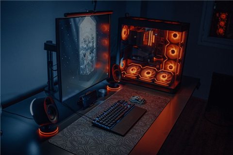 Modern desk setup with gaming PC and peripherals used for headset testing Modern desk setup with gaming PC and peripherals used for headset testing
