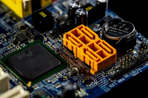 Close-up of a computer motherboard chipset representing internal PC hardware components Close-up of a computer motherboard chipset representing internal PC hardware components