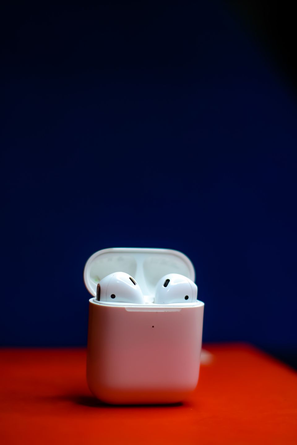 Wireless earbuds in white case shown up close Wireless earbuds in white case shown up close
