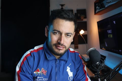 Content creator using a microphone and interface setup for streaming
