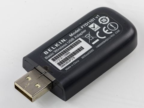 Belkin USB wireless network adapter plugged into a laptop showing the compact dongle design Belkin USB wireless network adapter plugged into a laptop showing the compact dongle design