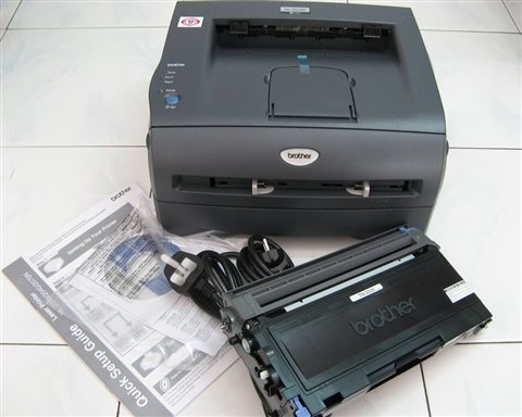 Compact monochrome laser printer on an office desk for fast document printing