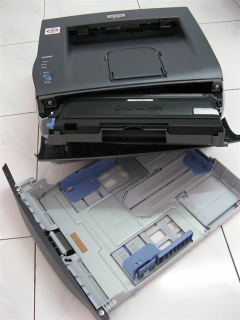 Printer paper tray with stacked sheets loaded for laser printing jobs Printer paper tray with stacked sheets loaded for laser printing jobs