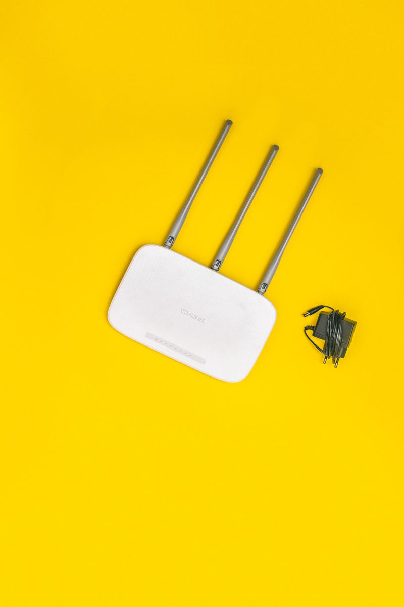 White wireless router with antennas representing a home network