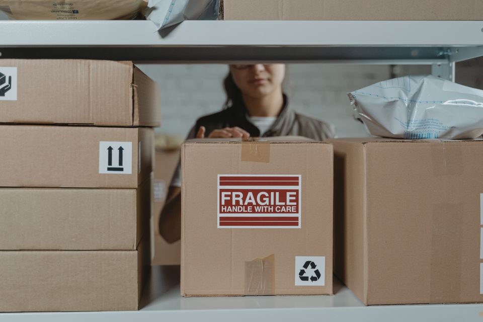 close up of a fragile shipping label printed and applied to a cardboard box close up of a fragile shipping label printed and applied to a cardboard box