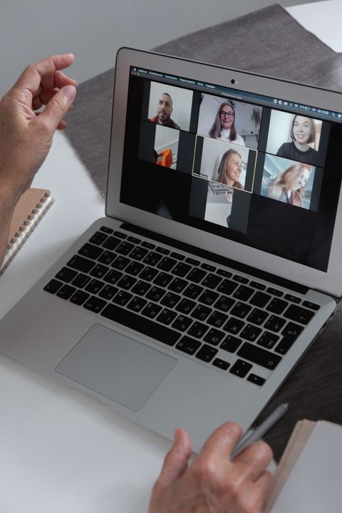 Group video call session shown on a laptop in a home office Group video call session shown on a laptop in a home office