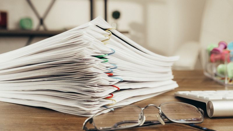 Stack of paperwork and documents ready to be scanned and filed