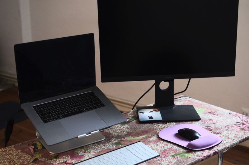 Laptop and monitor on a desk used for scanning software setup