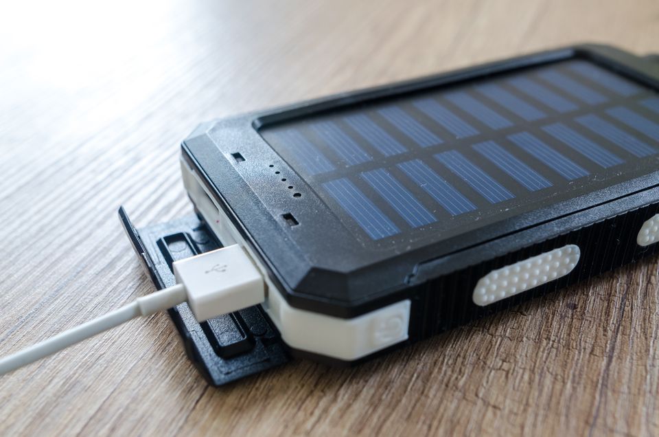 Portable charger with USB cable on a wooden surface Portable charger with USB cable on a wooden surface