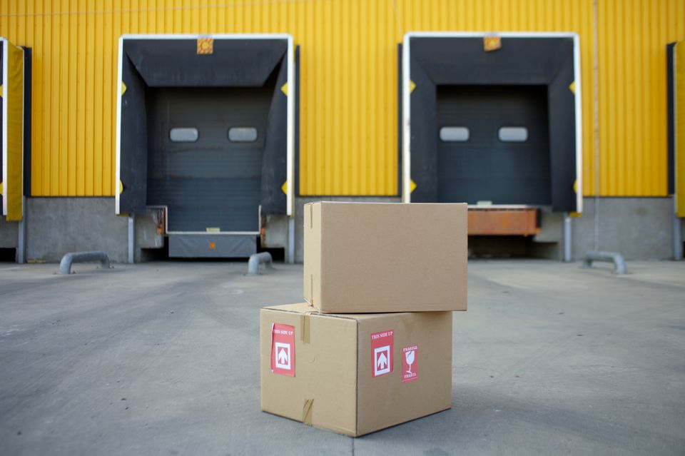 stacked cardboard boxes with shipping labels on warehouse shelving stacked cardboard boxes with shipping labels on warehouse shelving