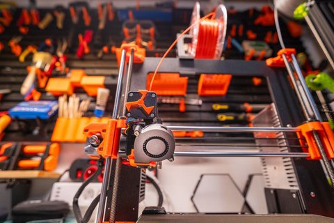 3D printer workbench setup with tools and filament spools around an FDM printer 3D printer workbench setup with tools and filament spools around an FDM printer