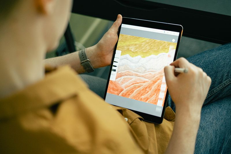 Digital artist sketching with a stylus after installing a pen display driver