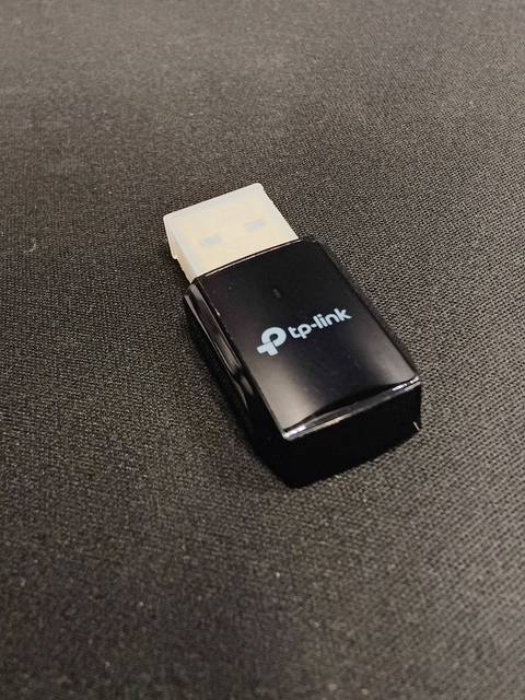 USB WiFi dongle adapter connected to a laptop computer USB WiFi dongle adapter connected to a laptop computer