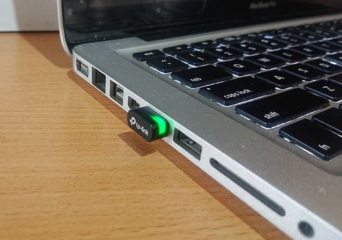 Nano USB wifi adapter plugged into a computer for wireless networking Nano USB wifi adapter plugged into a computer for wireless networking